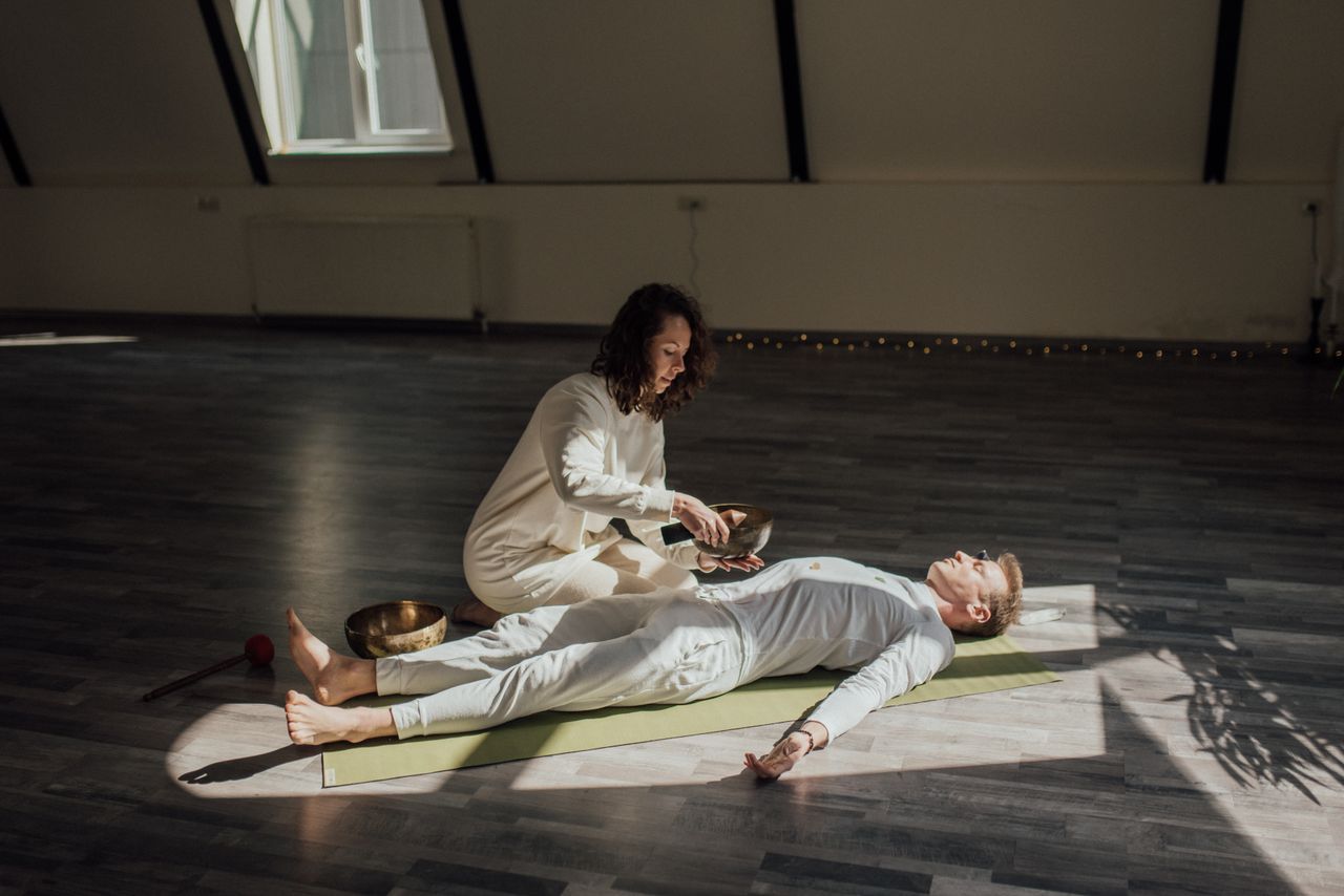 services-01 A serene meditation session with singing bowls for alternative healing indoors.