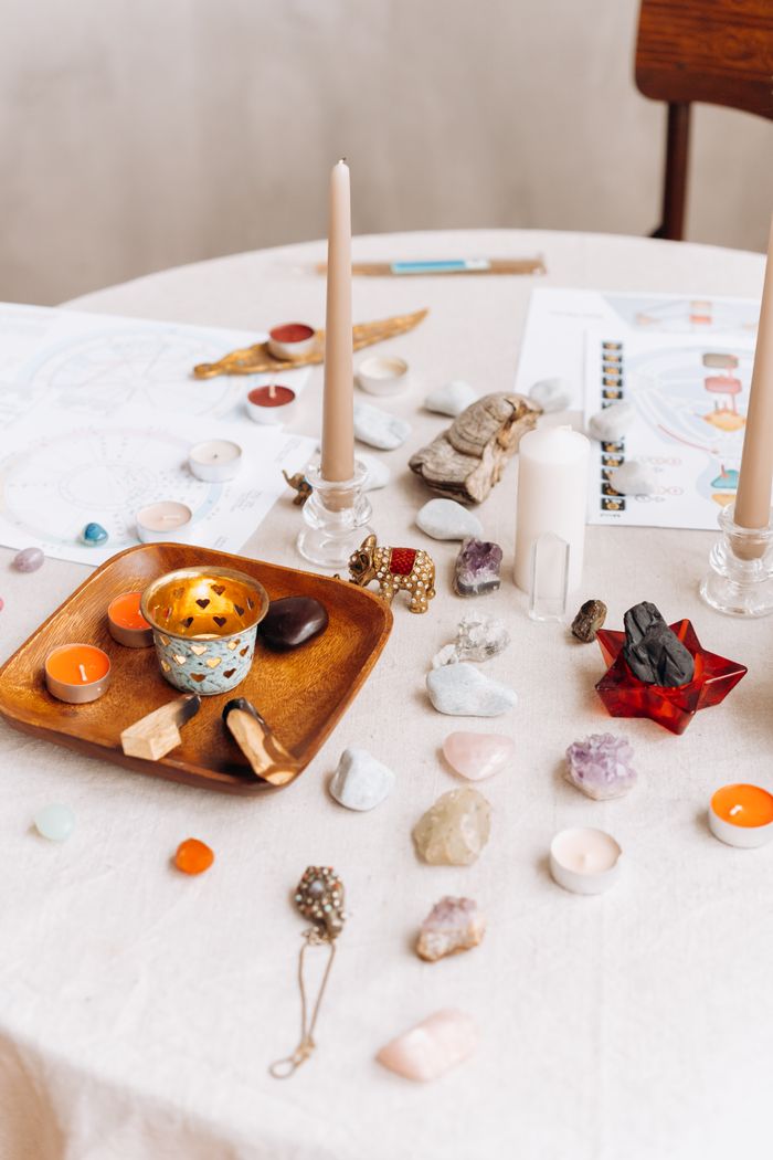 A serene tabletop setup featuring candles and healing stones for meditation.